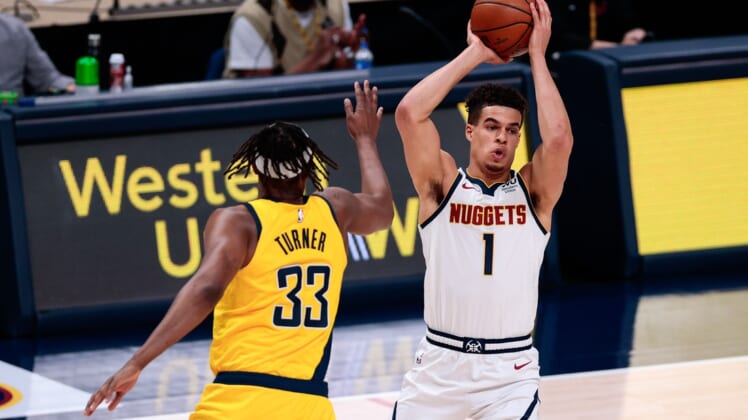 Mar 15, 2021; Denver, Colorado, USA; Denver Nuggets forward Michael Porter Jr. (1) looks to pass under pressure from Indiana Pacers center Myles Turner (33) in the second quarter at Ball Arena. Mandatory Credit: Isaiah J. Downing-USA TODAY Sports