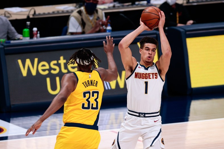 Mar 15, 2021; Denver, Colorado, USA; Denver Nuggets forward Michael Porter Jr. (1) looks to pass under pressure from Indiana Pacers center Myles Turner (33) in the second quarter at Ball Arena. Mandatory Credit: Isaiah J. Downing-USA TODAY Sports