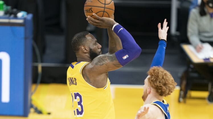 March 15, 2021; San Francisco, California, USA; Los Angeles Lakers forward LeBron James (23) shoots the basketball against Golden State Warriors guard Nico Mannion (2) during the second quarter at Chase Center. Mandatory Credit: Kyle Terada-USA TODAY Sports