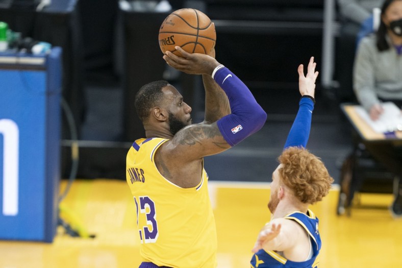 March 15, 2021; San Francisco, California, USA; Los Angeles Lakers forward LeBron James (23) shoots the basketball against Golden State Warriors guard Nico Mannion (2) during the second quarter at Chase Center. Mandatory Credit: Kyle Terada-USA TODAY Sports