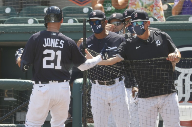 Mar 16, 2021; Lakeland, Florida, USA;  Detroit Tigers left fielder JaCoby Jones (21) is congratulated by manager A.J. Hinch (14) as je hits a home run during the second inning against the New York Yankees at Publix Field at Joker Marchant Stadium. Mandatory Credit: Kim Klement-USA TODAY Sports
