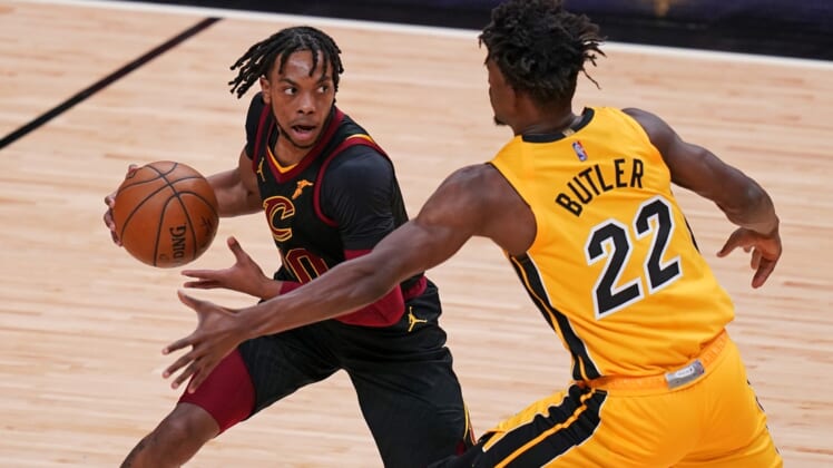 Mar 16, 2021; Miami, Florida, USA; Cleveland Cavaliers guard Darius Garland (10) controls the ball around Miami Heat forward Jimmy Butler (22) during the first half at American Airlines Arena. Mandatory Credit: Jasen Vinlove-USA TODAY Sports