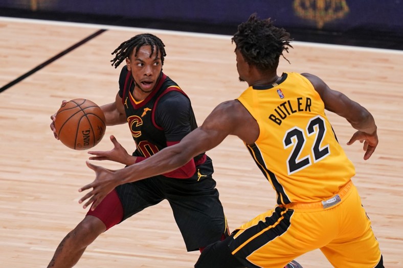 Mar 16, 2021; Miami, Florida, USA; Cleveland Cavaliers guard Darius Garland (10) controls the ball around Miami Heat forward Jimmy Butler (22) during the first half at American Airlines Arena. Mandatory Credit: Jasen Vinlove-USA TODAY Sports