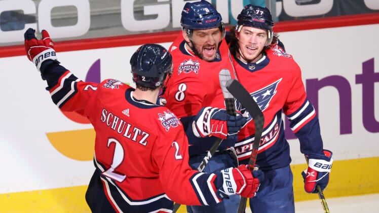 Mar 16, 2021; Washington, District of Columbia, USA; Washington Capitals left wing Alex Ovechkin (8) celebrates with teammates after scoring a goal against the New York Islanders in the second period at Capital One Arena. Ovechkin passed Phil Esposito for sixth all time on the NHL goal scoring list with the goal. Mandatory Credit: Geoff Burke-USA TODAY Sports