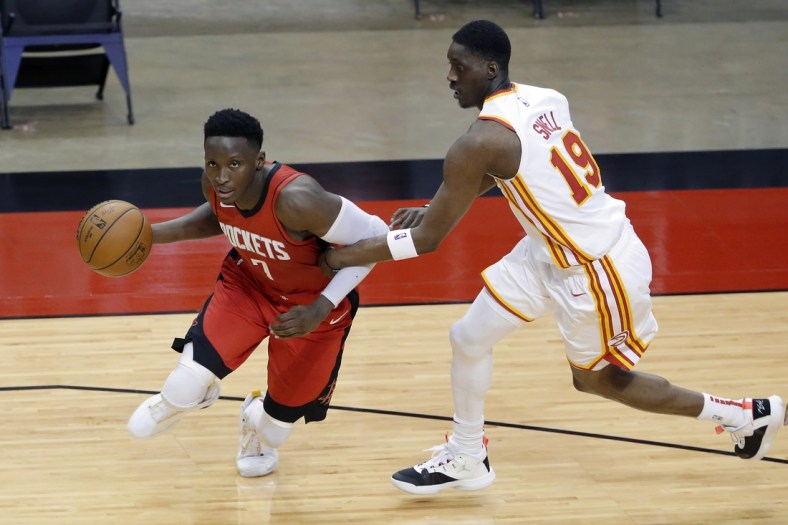 Mar 16, 2021; Houston, Texas, USA; Houston Rockets guard Victor Oladipo (7) is fouled as he drives around Atlanta Hawks guard Tony Snell (19) during the second half at Toyota Center. Mandatory Credit: Michael Wyke/POOL PHOTOS-USA TODAY Sports