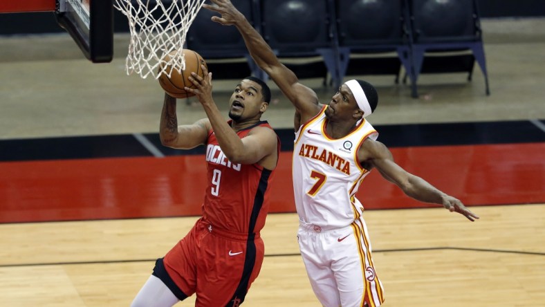 Mar 16, 2021; Houston, Texas, USA; Houston Rockets guard Mason Jones (9) puts up a shot in front of Atlanta Hawks guard Rajon Rondo (7) during the second half at Toyota Center. Mandatory Credit: Michael Wyke/POOL PHOTOS-USA TODAY Sports