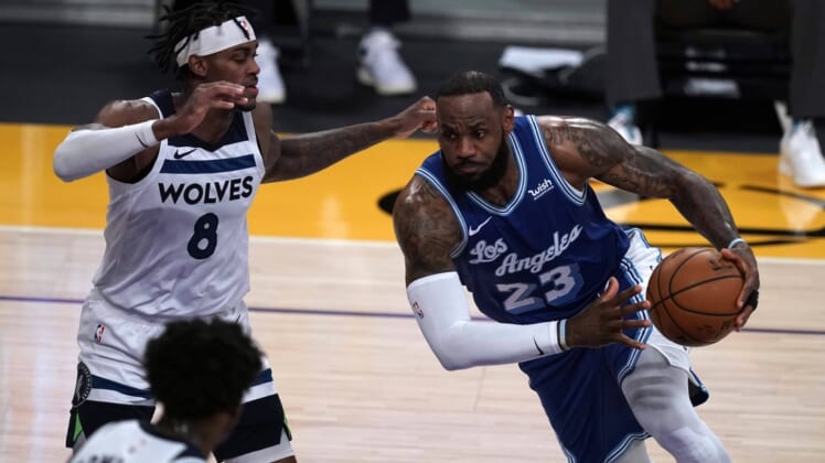Mar 16, 2021; Los Angeles, California, USA; Los Angeles Lakers forward LeBron James (23) is defended by Minnesota Timberwolves forward Jarred Vanderbilt (8) in the first half at Staples Center. Mandatory Credit: Kirby Lee-USA TODAY Sports