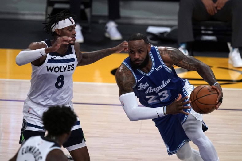 Mar 16, 2021; Los Angeles, California, USA; Los Angeles Lakers forward LeBron James (23) is defended by Minnesota Timberwolves forward Jarred Vanderbilt (8) in the first half at Staples Center. Mandatory Credit: Kirby Lee-USA TODAY Sports