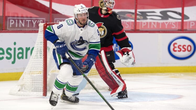 Mar 17, 2021; Ottawa, Ontario, CAN; Vancouver Canucks center J.T. Miller (9) skates away from  Ottawa Senators goalie Joey Daccord (34) following a shot on goal in the first period at the Canadian Tire Centre. Mandatory Credit: Marc DesRosiers-USA TODAY Sports