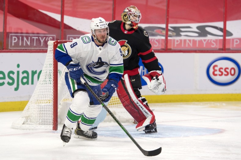 Mar 17, 2021; Ottawa, Ontario, CAN; Vancouver Canucks center J.T. Miller (9) skates away from  Ottawa Senators goalie Joey Daccord (34) following a shot on goal in the first period at the Canadian Tire Centre. Mandatory Credit: Marc DesRosiers-USA TODAY Sports