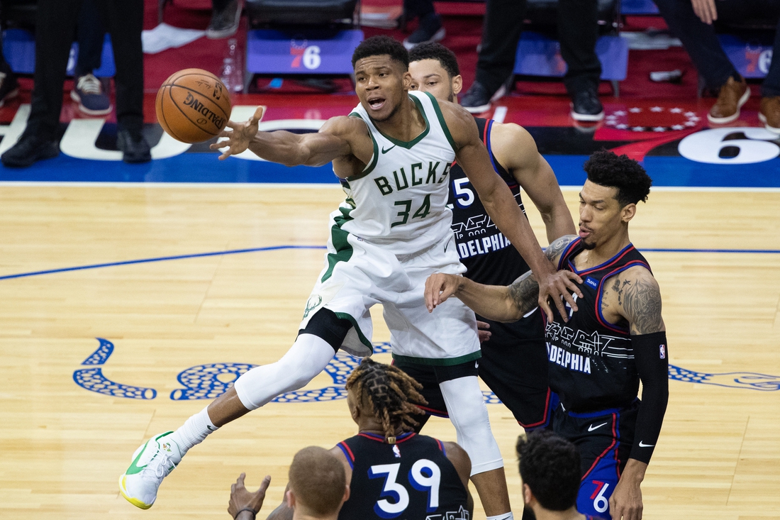 Mar 17, 2021; Philadelphia, Pennsylvania, USA; Milwaukee Bucks forward Giannis Antetokounmpo (34) reaches for a loose ball in front of Philadelphia 76ers forward Danny Green (14) during the fourth quarter at Wells Fargo Center. Mandatory Credit: Bill Streicher-USA TODAY Sports