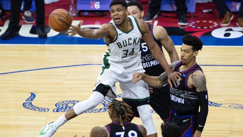 Mar 17, 2021; Philadelphia, Pennsylvania, USA; Milwaukee Bucks forward Giannis Antetokounmpo (34) reaches for a loose ball in front of Philadelphia 76ers forward Danny Green (14) during the fourth quarter at Wells Fargo Center. Mandatory Credit: Bill Streicher-USA TODAY Sports