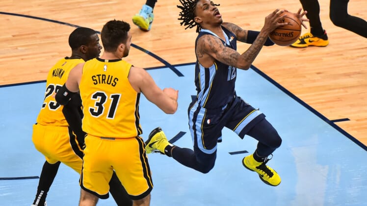 Mar 17, 2021; Memphis, Tennessee, USA;  Memphis Grizzlies guard Ja Morant (12) goes to the basket against Miami Heat guard Max Strus (31) during the first half at FedExForum. Mandatory Credit: Justin Ford-USA TODAY Sports