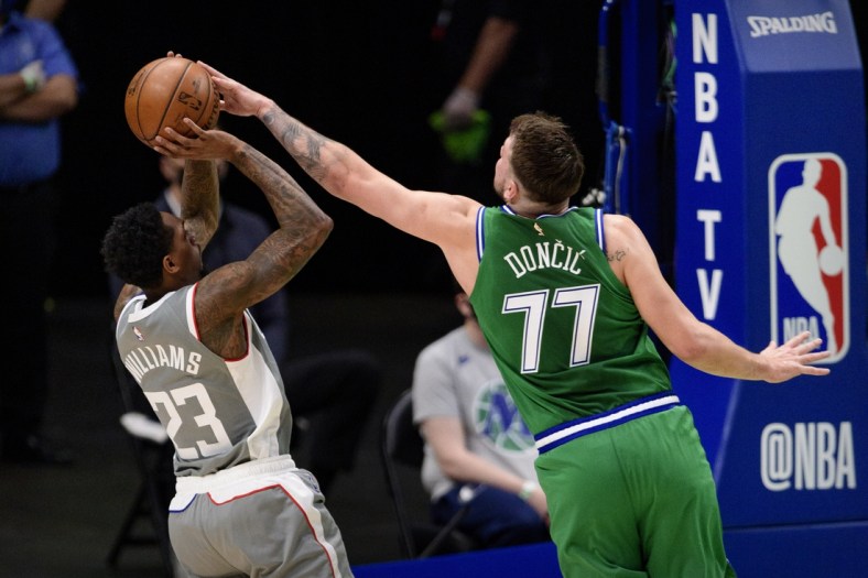 Mar 17, 2021; Dallas, Texas, USA; Dallas Mavericks guard Luka Doncic (77) blocks a shot by LA Clippers guard Lou Williams (23) during the second quarter at the American Airlines Center. Mandatory Credit: Jerome Miron-USA TODAY Sports