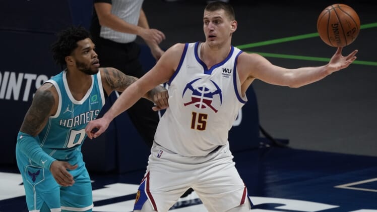 Mar 17, 2021; Denver, Colorado, USA; Denver Nuggets center Nikola Jokic (15) controls the ball against Charlotte Hornets forward Miles Bridges (0) in the second half at Ball Arena. Mandatory Credit: Ron Chenoy-USA TODAY Sports