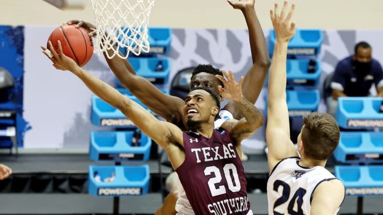 Mar 18, 2021; Bloomington, Indiana, USA; Texas Southern Tigers guard Michael Weathers (20) shoots between Mount St. Mary's Mountaineers forward Nana Opoku (left) and forward Frantisek Barton (right) during the first half in the First Four of the 2021 NCAA Tournament at Simon Skjodt Assembly Hall. Mandatory Credit: Trevor Ruszkowski-USA TODAY Sports