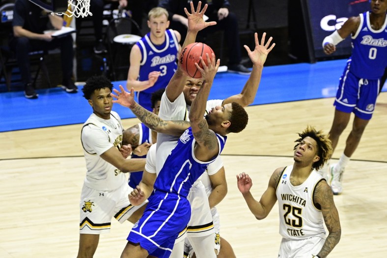 Mar 18, 2021; West Lafayette, Indiana, USA; Wichita State Shockers guard Dexter Dennis (0) defends against Drake Bulldogs forward Tremell Murphy (2) in the first half during the First Four of the 2021 NCAA Tournament at Mackey Arena. Mandatory Credit: Marc Lebryk-USA TODAY Sports
