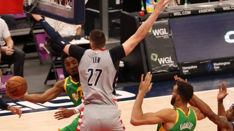 Mar 18, 2021; Washington, District of Columbia, USA; Utah Jazz guard Donovan Mitchell (45) passes the ball to Jazz center Rudy Gobert (27) as Washington Wizards center Alex Len (27) defends in the first quarter at Capital One Arena. Mandatory Credit: Geoff Burke-USA TODAY Sports