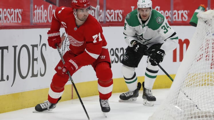 Mar 18, 2021; Detroit, Michigan, USA; Detroit Red Wings center Dylan Larkin (71) skates away from Dallas Stars right wing Denis Gurianov (34) during the first period at Little Caesars Arena. Mandatory Credit: Raj Mehta-USA TODAY Sports