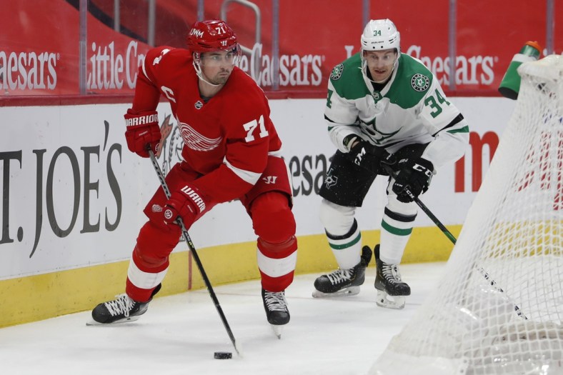 Mar 18, 2021; Detroit, Michigan, USA; Detroit Red Wings center Dylan Larkin (71) skates away from Dallas Stars right wing Denis Gurianov (34) during the first period at Little Caesars Arena. Mandatory Credit: Raj Mehta-USA TODAY Sports