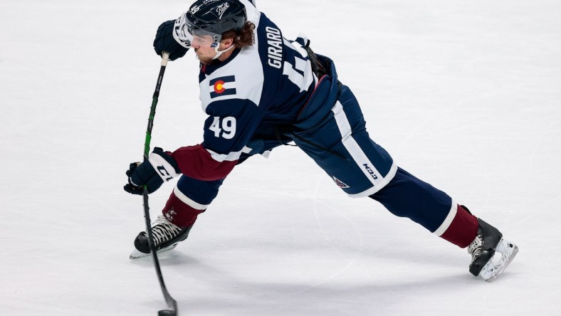 Mar 18, 2021; Denver, Colorado, USA; Colorado Avalanche defenseman Samuel Girard (49) takes a shot in the first period against the Minnesota Wild at Ball Arena. Mandatory Credit: Isaiah J. Downing-USA TODAY Sports