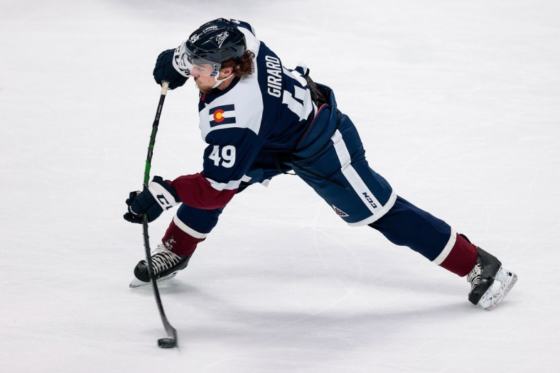 Mar 18, 2021; Denver, Colorado, USA; Colorado Avalanche defenseman Samuel Girard (49) takes a shot in the first period against the Minnesota Wild at Ball Arena. Mandatory Credit: Isaiah J. Downing-USA TODAY Sports