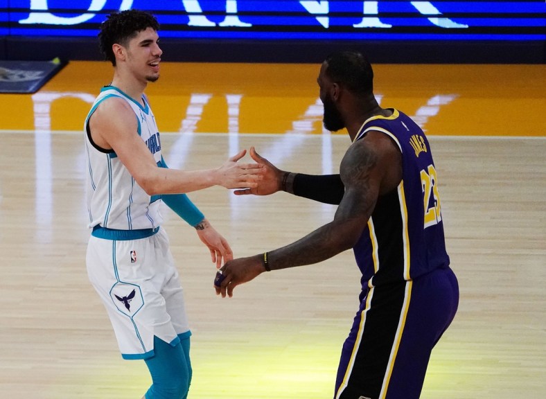 Mar 18, 2021; Los Angeles, California, USA; Charlotte Hornets guard LaMelo Ball (2) greets Los Angeles Lakers forward LeBron James (23) before the first half at Staples Center. Mandatory Credit: Gary A. Vasquez-USA TODAY Sports