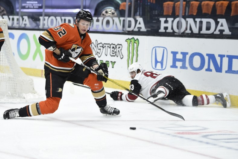 Mar 18, 2021; Anaheim, California, USA; Anaheim Ducks defenseman Jacob Larsson (32) looks for the puck against Arizona Coyotes right wing Conor Garland (83) during the second period at Honda Center. Mandatory Credit: Kelvin Kuo-USA TODAY Sports