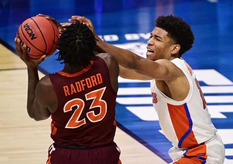 Mar 19, 2021; Indianapolis, Indiana, USA; Virginia Tech Hokies guard Tyrece Radford (23) controls the ball against Florida Gators guard Noah Locke (10) during the first round of the 2021 NCAA Tournament at Hinkle Fieldhouse. Mandatory Credit: Marc Lebryk-USA TODAY Sports
