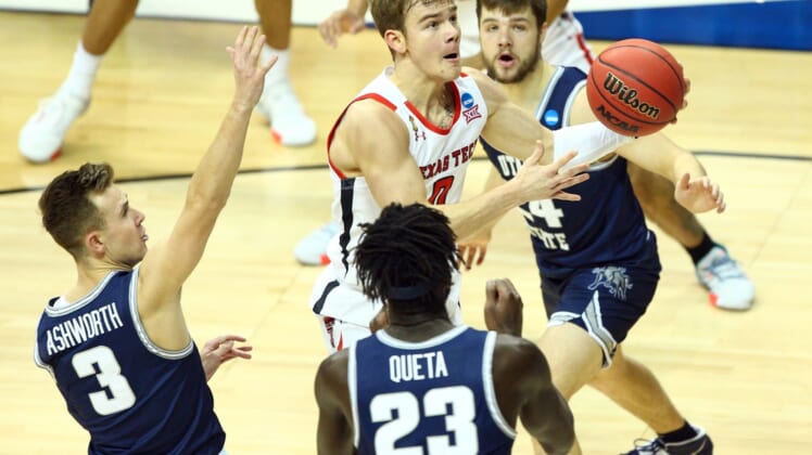 Mar 19, 2021; Bloomington, Indiana, USA; Texas Tech Red Raiders guard Mac McClung (0) moves to the basket against Utah State Aggies guard Steven Ashworth (3) center Neemias Queta (23) and guard Rollie Worster (24) during the first half in the first round of the 2021 NCAA Tournament at Simon Skjodt Assembly Hall. Mandatory Credit: Jordan Prather-USA TODAY Sports