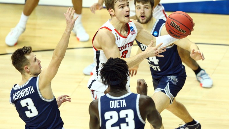 Mar 19, 2021; Bloomington, Indiana, USA; Texas Tech Red Raiders guard Mac McClung (0) moves to the basket against Utah State Aggies guard Steven Ashworth (3) center Neemias Queta (23) and guard Rollie Worster (24) during the first half in the first round of the 2021 NCAA Tournament at Simon Skjodt Assembly Hall. Mandatory Credit: Jordan Prather-USA TODAY Sports