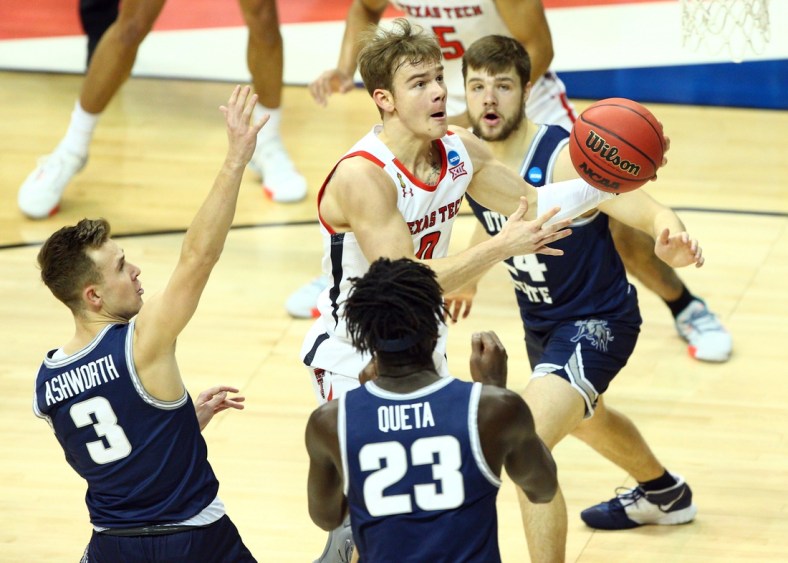 Mar 19, 2021; Bloomington, Indiana, USA; Texas Tech Red Raiders guard Mac McClung (0) moves to the basket against Utah State Aggies guard Steven Ashworth (3) center Neemias Queta (23) and guard Rollie Worster (24) during the first half in the first round of the 2021 NCAA Tournament at Simon Skjodt Assembly Hall. Mandatory Credit: Jordan Prather-USA TODAY Sports