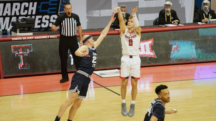 Mar 19, 2021; Bloomington, Indiana, USA; Texas Tech Red Raiders guard Mac McClung (0) shoots against Utah State Aggies guard Brock Miller (22) during the second half in the first round of the 2021 NCAA Tournament at Simon Skjodt Assembly Hall. Mandatory Credit: Robert Goddin-USA TODAY Sports