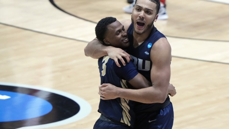 Mar 19, 2021; West Lafayette, Indiana, USA; Oral Roberts Golden Eagles guard Max Abmas (3) and forward Kevin Obanor (0) celebrate after an overtime victory over the Ohio State Buckeyes in the first round of the 2021 NCAA Tournament at Mackey Arena. Mandatory Credit: Mike Dinovo-USA TODAY Sports