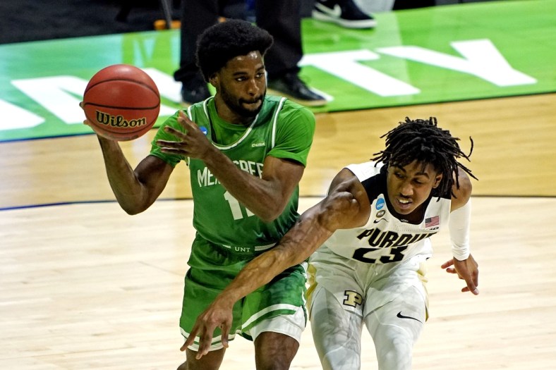 Mar 19, 2021; Indianapolis, Indiana, USA; North Texas Mean Green guard JJ Murray (11) handles the ball against Purdue Boilermakers guard Jaden Ivey (23) during the first half in the first round of the 2021 NCAA Tournament at Lucas Oil Stadium. Mandatory Credit: Andrew Nelles-USA TODAY Sports