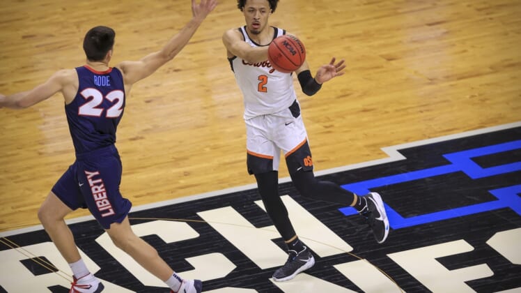 Mar 19, 2021; Indianapolis, IN, USA; Oklahoma State Cowboys guard Cade Cunningham (2) passes the ball past Liberty Flames forward Kyle Rode (22) during the first round of the 2021 NCAA Tournament at Indiana Farmers Coliseum.  Mandatory Credit: Aaron Doster-USA TODAY Sports