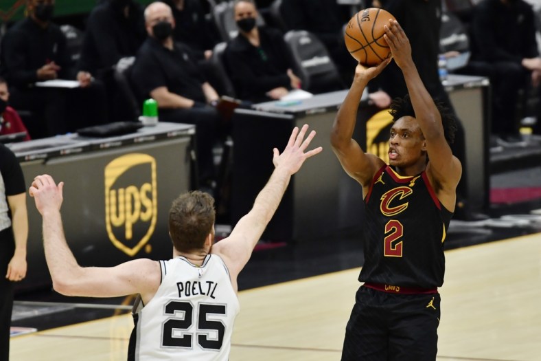 Mar 19, 2021; Cleveland, Ohio, USA; Cleveland Cavaliers guard Collin Sexton (2) shoots over the defense of  San Antonio Spurs center Jakob Poeltl (25) during the third quarter at Rocket Mortgage FieldHouse. Mandatory Credit: Ken Blaze-USA TODAY Sports