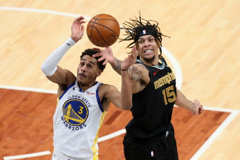 Mar 19, 2021; Memphis, Tennessee, USA; Memphis Grizzlies forward Brandon Clarke (15) and Golden State Warriors guard Jordan Poole (3) reach for a loose ball during the second quarter at FedExForum. Mandatory Credit: Nelson Chenault-USA TODAY Sports