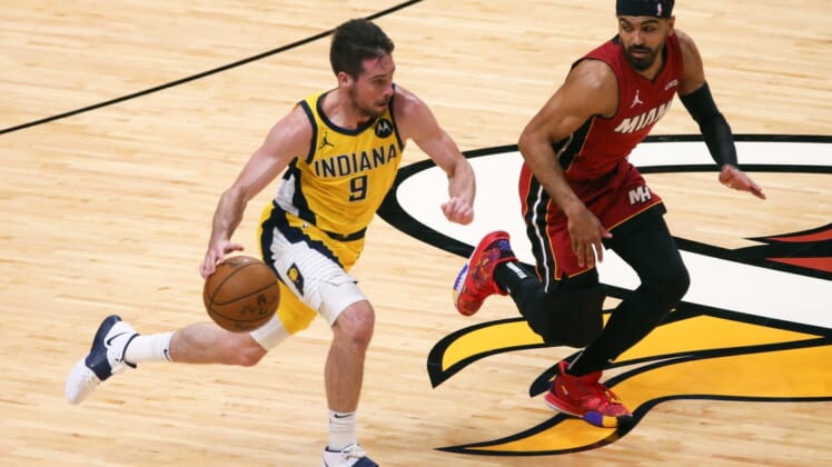 Mar 19, 2021; Miami, Florida, USA; Indiana Pacers guard T.J. McConnell (9) controls the basketball around Miami Heat guard Gabe Vincent (2) during the second quarter at American Airlines Arena. Mandatory Credit: Sam Navarro-USA TODAY Sports