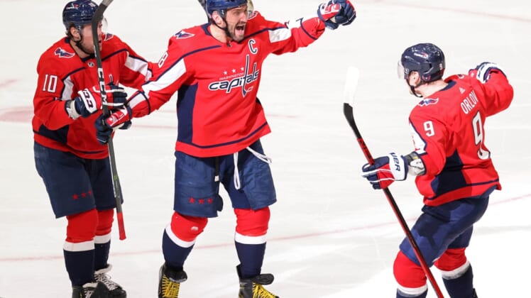 Mar 19, 2021; Washington, District of Columbia, USA;Washington Capitals left wing Alex Ovechkin (8) celebrates with Capitals defenseman Dmitry Orlov (9) and Capitals right wing Daniel Sprong (10) after scoring the go ahead goal against the New York Rangers in the third period at Capital One Arena. Mandatory Credit: Geoff Burke-USA TODAY Sports
