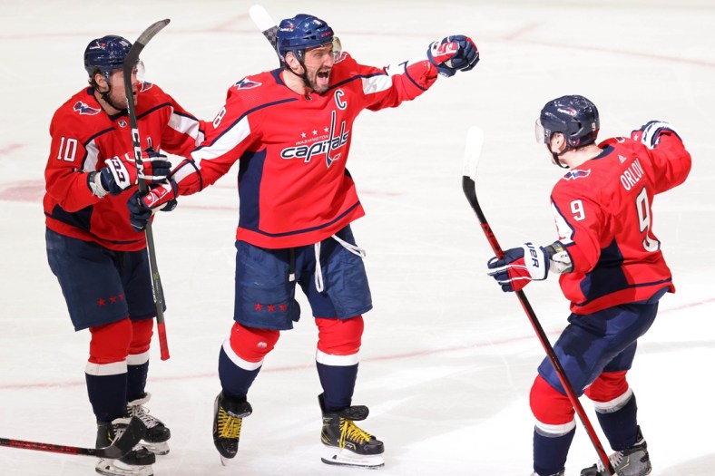 Mar 19, 2021; Washington, District of Columbia, USA;Washington Capitals left wing Alex Ovechkin (8) celebrates with Capitals defenseman Dmitry Orlov (9) and Capitals right wing Daniel Sprong (10) after scoring the go ahead goal against the New York Rangers in the third period at Capital One Arena. Mandatory Credit: Geoff Burke-USA TODAY Sports