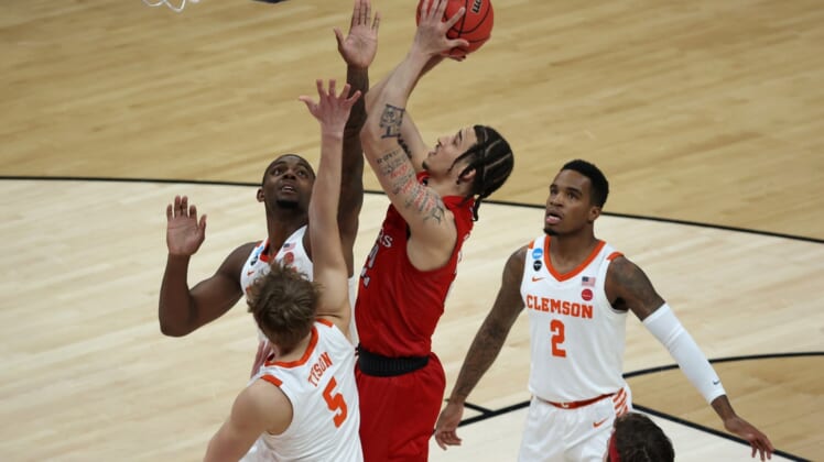 Mar 19, 2021; Indianapolis, Indiana, USA; Rutgers Scarlet Knights guard Caleb McConnell (22) shoots the ball over Clemson Tigers forward Hunter Tyson (5) during the first half in the first round of the 2021 NCAA Tournament at Bankers Life Fieldhouse. Mandatory Credit: Trevor Ruszkowski-USA TODAY Sports