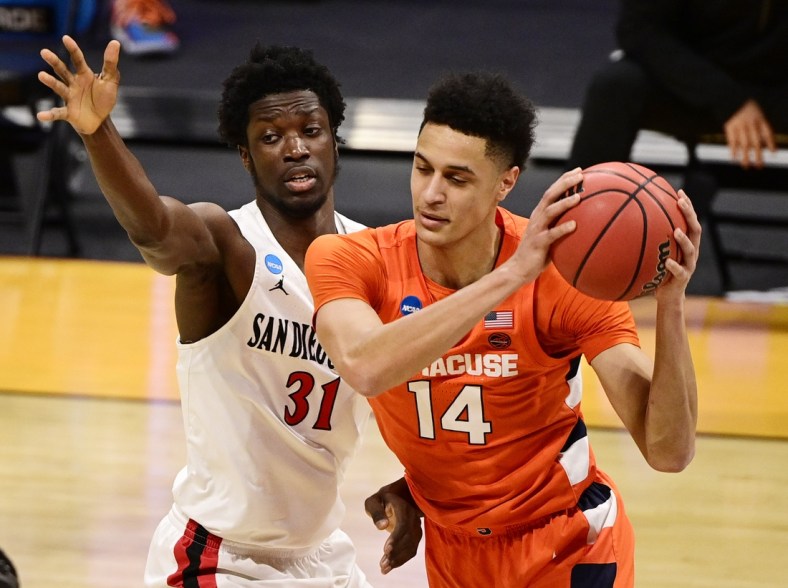 Mar 19, 2021; Indianapolis, Indiana, USA; Syracuse Orange center Jesse Edwards (14) is defended by San Diego State Aztecs forward Nathan Mensah (31) during the first round of the 2021 NCAA Tournament at Hinkle Fieldhouse. Mandatory Credit: Marc Lebryk-USA TODAY Sports