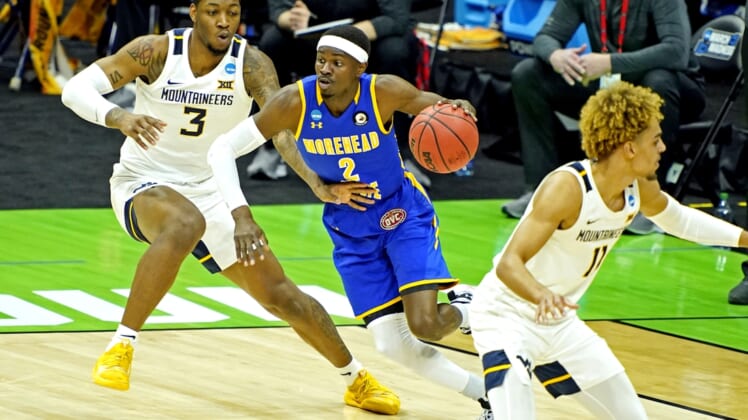 Mar 19, 2021; Indianapolis, Indiana, USA; Morehead State Eagles guard KJ Hunt Jr. (2) drives to the basket against West Virginia Mountaineers forward Gabe Osabuohien (3) during the first half in the first round of the 2021 NCAA Tournament at Lucas Oil Stadium. Mandatory Credit: Andrew Nelles-USA TODAY Sports
