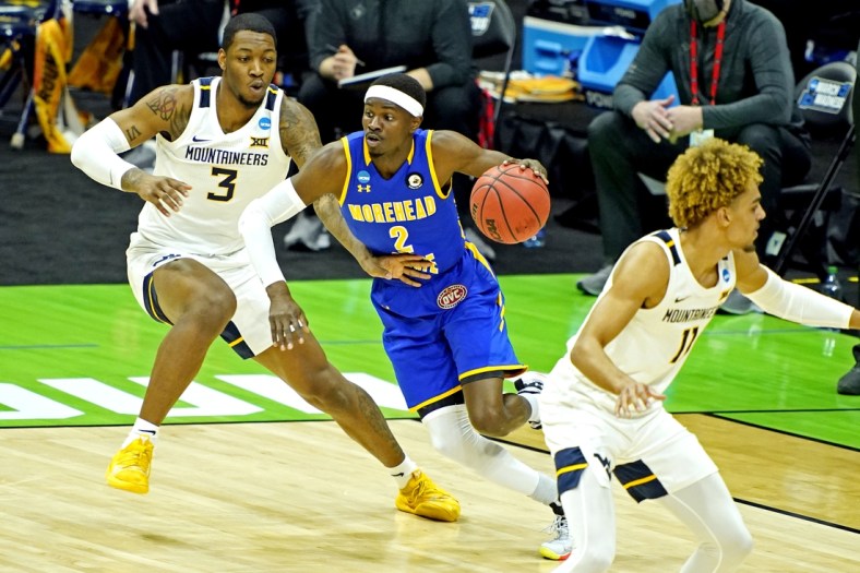 Mar 19, 2021; Indianapolis, Indiana, USA; Morehead State Eagles guard KJ Hunt Jr. (2) drives to the basket against West Virginia Mountaineers forward Gabe Osabuohien (3) during the first half in the first round of the 2021 NCAA Tournament at Lucas Oil Stadium. Mandatory Credit: Andrew Nelles-USA TODAY Sports