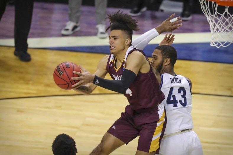 Mar 19, 2021; Indianapolis, IN, USA; Winthrop Eagles forward Kelton Talford (4) grabs a rebound in front of Villanova Wildcats forward Eric Dixon (43) during the first round of the 2021 NCAA Tournament at Indiana Farmers Coliseum.  Mandatory Credit: Katie Stratman-USA TODAY Sports