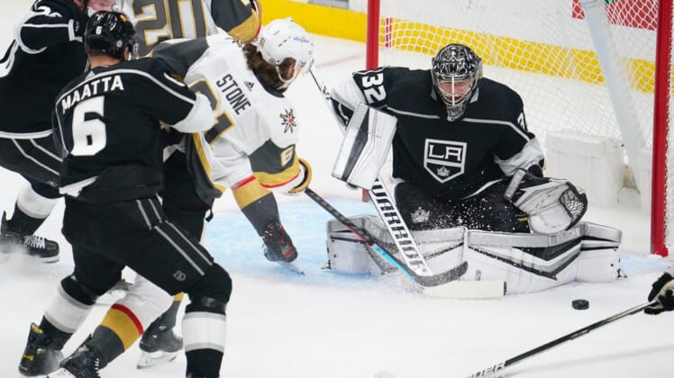 Mar 19, 2021; Los Angeles, California, USA; Vegas Golden Knights right wing Mark Stone (61) takes a shot past Los Angeles Kings defenseman Olli Maatta (6) as Los Angeles Kings goaltender Jonathan Quick (32) defends the goal during the first period at Staples Center. Mandatory Credit: Robert Hanashiro-USA TODAY Sports