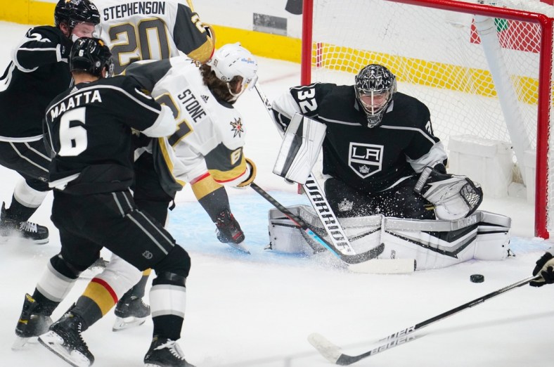 Mar 19, 2021; Los Angeles, California, USA; Vegas Golden Knights right wing Mark Stone (61) takes a shot past Los Angeles Kings defenseman Olli Maatta (6) as Los Angeles Kings goaltender Jonathan Quick (32) defends the goal during the first period at Staples Center. Mandatory Credit: Robert Hanashiro-USA TODAY Sports