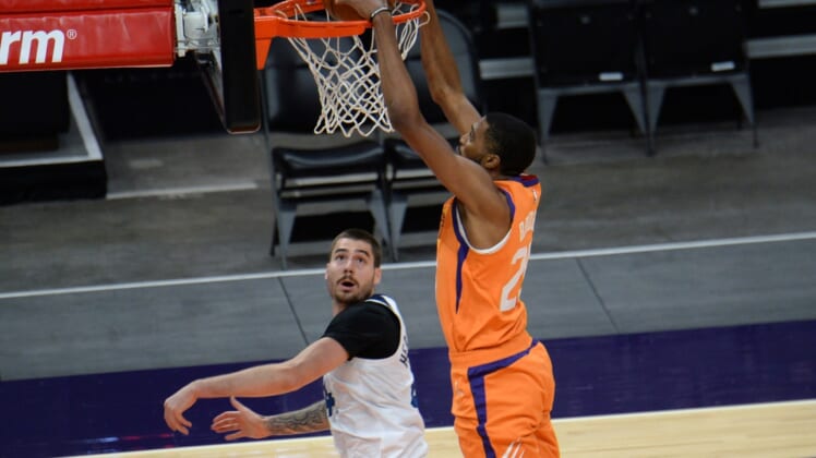 Mar 19, 2021; Phoenix, Arizona, USA; Phoenix Suns forward Mikal Bridges (25) dunks over Minnesota Timberwolves forward Juancho Hernangomez (41) during the second half at Phoenix Suns Arena. Mandatory Credit: Joe Camporeale-USA TODAY Sports