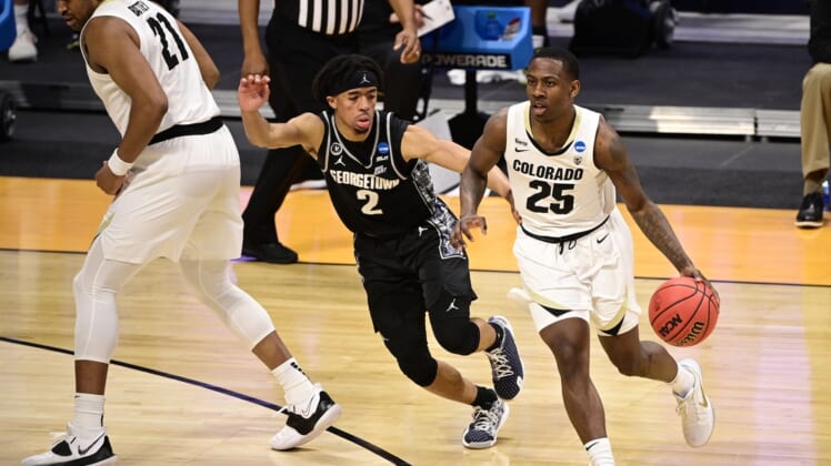 Mar 20, 2021; Indianapolis, Indiana, USA; Colorado Buffaloes guard McKinley Wright IV (25) dribbles against Georgetown Hoyas guard Dante Harris (2) during the first round of the 2021 NCAA Tournament at Hinkle Fieldhouse. Mandatory Credit: Marc Lebryk-USA TODAY Sports